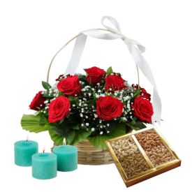 Basket of red roses, dry fruits and diya
