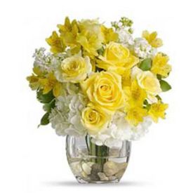 Bouquet of white hydrangea, yellow roses,yellow alstroemeria, with clear glass vase