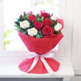 Bunch of 15 red and white roses with paper packing