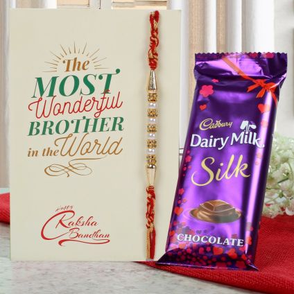 white rakhi and chocolates.